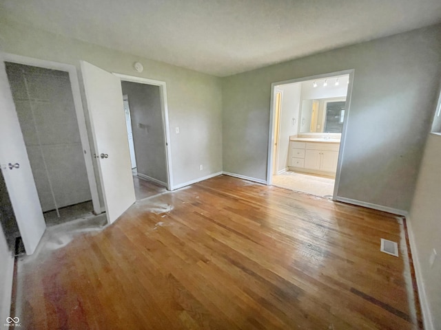 5667 Broyles Rd, Avon, IN 46123 - unfurnished bedroom with light wood finished floors, a closet, and ensuite bathroom