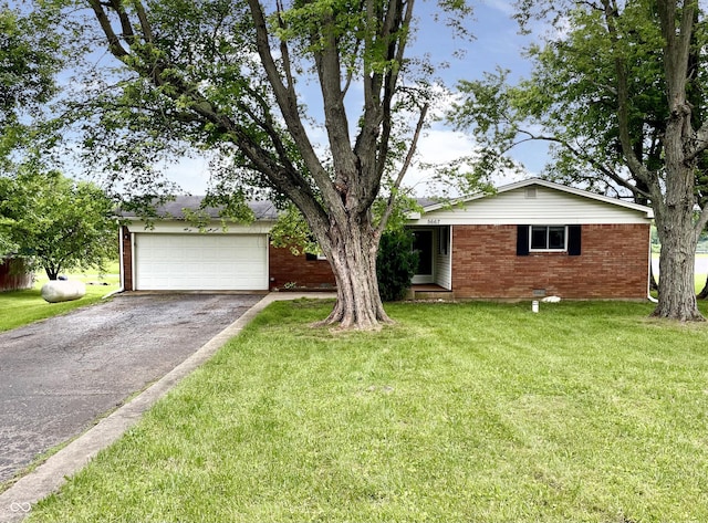 5667 Broyles Rd, Avon, IN 46123 - view of front of home with a garage, driveway, brick siding, and a front lawn