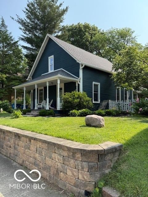 6107 Broadway St, Indianapolis, IN 46220 - view of front of house featuring a porch, a front yard, and a shingled roof