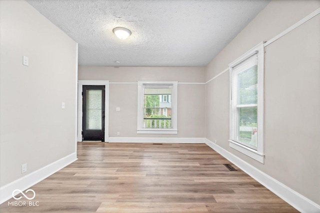 57 E S St, Mooresville, IN 46158 - empty room with light wood-style floors and a textured ceiling