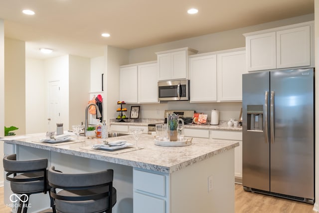 3541 N Hackberry St N, Bloomington, IN 47404 - kitchen featuring stainless steel appliances, white cabinetry, light wood-style floors, light countertops, and recessed lighting