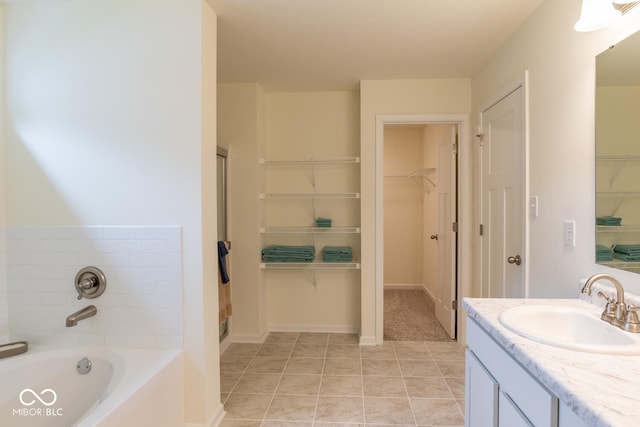 3541 N Hackberry St N, Bloomington, IN 47404 - full bathroom with a spacious closet, a bath, vanity, and tile patterned flooring