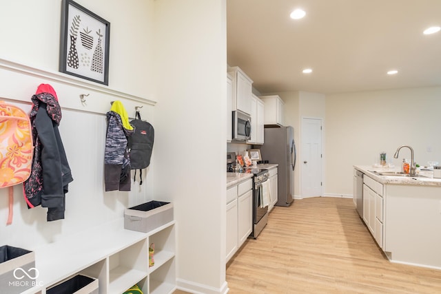 3541 N Hackberry St N, Bloomington, IN 47404 - kitchen featuring appliances with stainless steel finishes, light wood finished floors, white cabinets, and recessed lighting