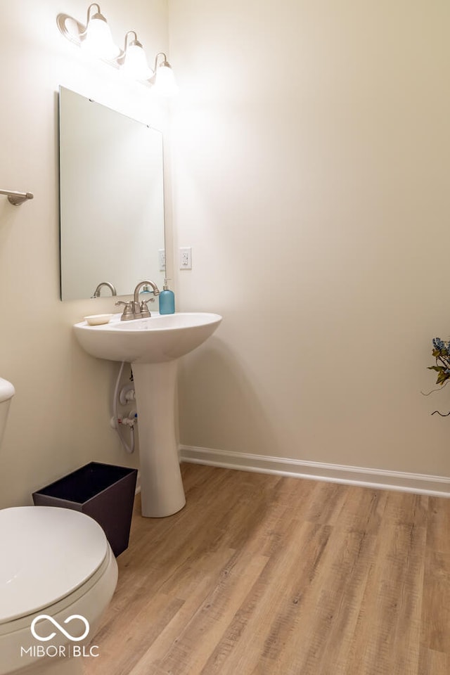 3541 N Hackberry St N, Bloomington, IN 47404 - half bathroom with wood finished floors and toilet