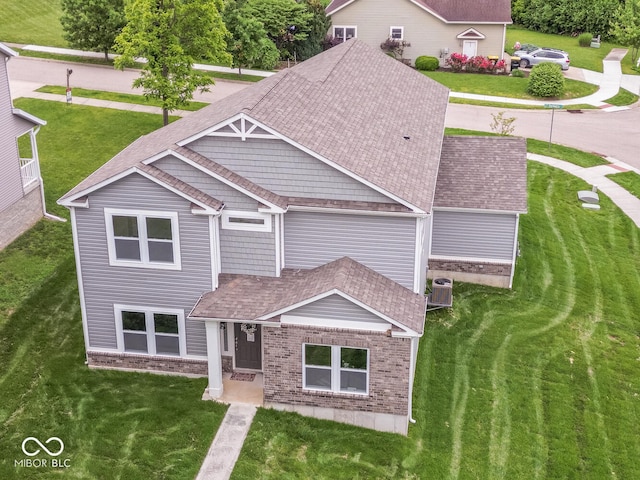 3541 N Hackberry St N, Bloomington, IN 47404 - view of front facade with brick siding, a front yard, and roof with shingles
