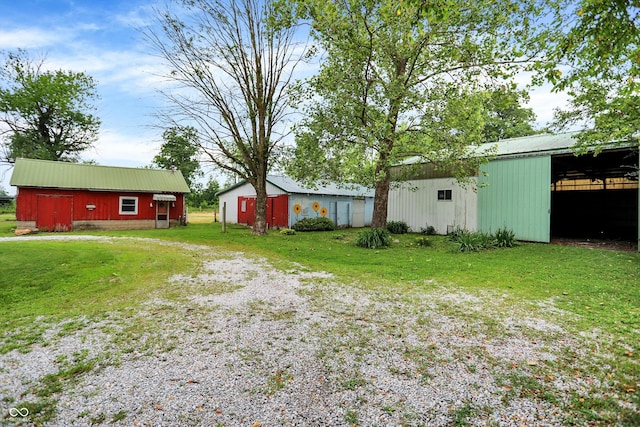 12471 N 100 E, Alexandria, IN 46001 - view of green lawn with a pole building, driveway, and an outbuilding