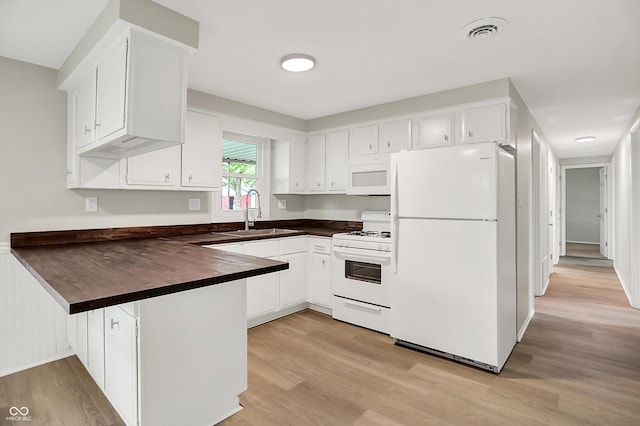 12471 N 100 E, Alexandria, IN 46001 - kitchen with white appliances, a peninsula, light wood-style flooring, and white cabinets