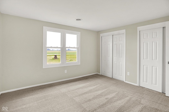 12471 N 100 E, Alexandria, IN 46001 - unfurnished bedroom featuring carpet flooring and two closets