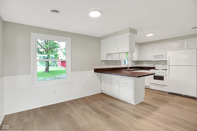 12471 N 100 E, Alexandria, IN 46001 - kitchen featuring white appliances, wainscoting, a peninsula, light wood-style flooring, and white cabinetry
