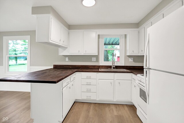 12471 N 100 E, Alexandria, IN 46001 - kitchen with white appliances, a peninsula, dark countertops, light wood-style flooring, and wainscoting