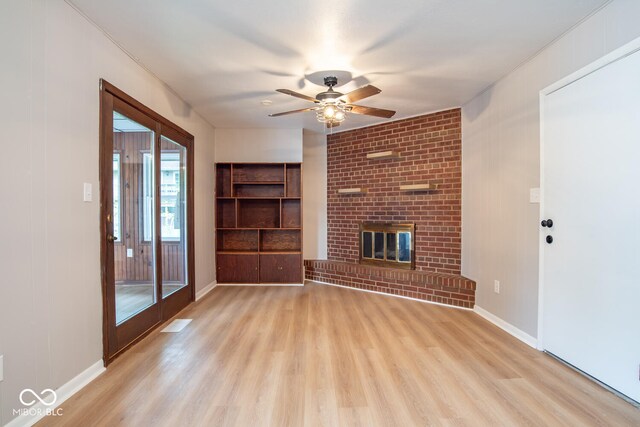 3212 S Fairington Dr, Bloomington, IN 47403 - unfurnished living room featuring light wood-style flooring, a ceiling fan, and a fireplace