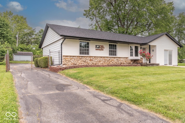 3212 S Fairington Dr, Bloomington, IN 47403 - ranch-style home featuring driveway, stone siding, a front yard, and roof with shingles