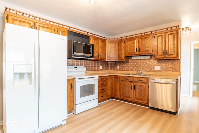 3212 S Fairington Dr, Bloomington, IN 47403 - kitchen with white appliances, light countertops, light wood-type flooring, and tasteful backsplash