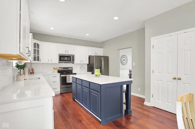 13191 Roma, Carmel, IN 46074 - kitchen featuring stainless steel appliances, white cabinets, dark wood finished floors, backsplash, and glass insert cabinets