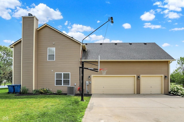 13191 Roma, Carmel, IN 46074 - rear view of house with a lawn, a chimney, driveway, and a garage