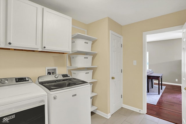 13191 Roma, Carmel, IN 46074 - laundry area featuring separate washer and dryer, cabinet space, and light wood finished floors