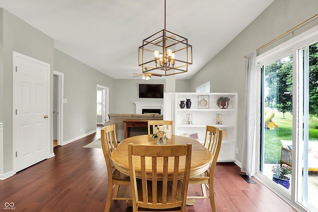 13191 Roma, Carmel, IN 46074 - dining space with healthy amount of natural light, dark wood finished floors, a chandelier, and a fireplace