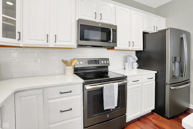 13191 Roma, Carmel, IN 46074 - kitchen with appliances with stainless steel finishes, dark wood-style flooring, white cabinetry, and tasteful backsplash