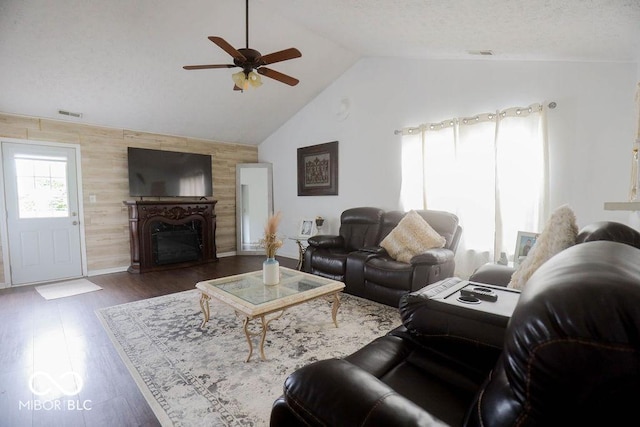 982 Ramsgate Rd, Greenwood, IN 46143 - living area with vaulted ceiling, ceiling fan, a fireplace, wood walls, and wood finished floors