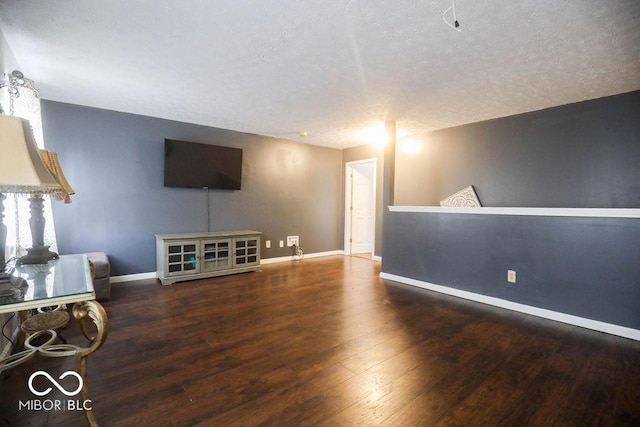 982 Ramsgate Rd, Greenwood, IN 46143 - unfurnished living room with wood finished floors and a textured ceiling