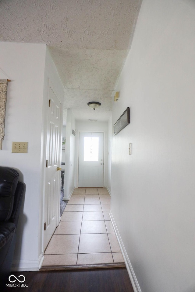 982 Ramsgate Rd, Greenwood, IN 46143 - doorway to outside with a textured ceiling and light tile patterned floors