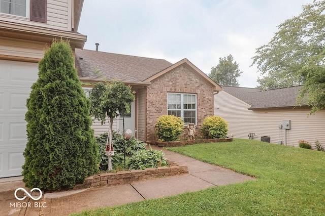 982 Ramsgate Rd, Greenwood, IN 46143 - entrance to property with a lawn, brick siding, a shingled roof, and a garage