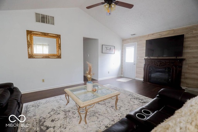 982 Ramsgate Rd, Greenwood, IN 46143 - living area featuring a ceiling fan, a glass covered fireplace, wood finished floors, an accent wall, and high vaulted ceiling