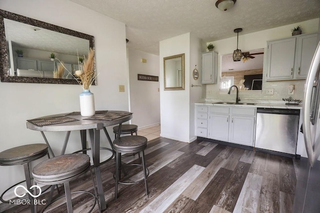 982 Ramsgate Rd, Greenwood, IN 46143 - kitchen with dishwasher, dark wood-style flooring, backsplash, light countertops, and a ceiling fan