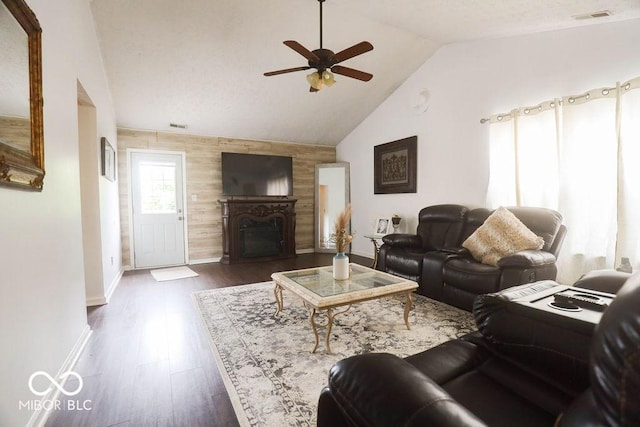 982 Ramsgate Rd, Greenwood, IN 46143 - living room with a ceiling fan, vaulted ceiling, a fireplace, an accent wall, and dark wood-style floors