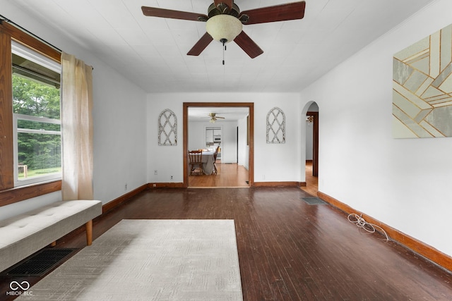 2211 S Andrews Rd, Yorktown, IN 47396 - unfurnished living room featuring a ceiling fan, wood-type flooring, and arched walkways