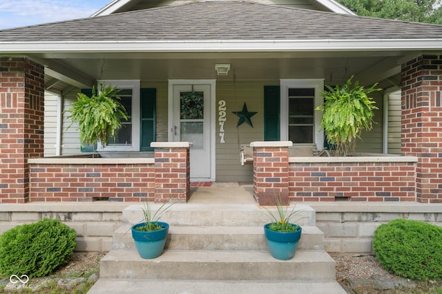 2211 S Andrews Rd, Yorktown, IN 47396 - view of exterior entry with brick siding and a shingled roof