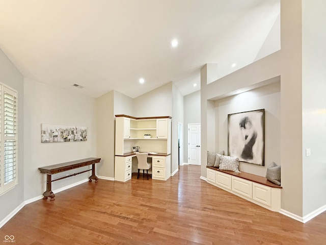 9302 N Bayland Dr, Mccordsville, IN 46055 - unfurnished living room featuring built in study area, light wood-type flooring, high vaulted ceiling, and recessed lighting