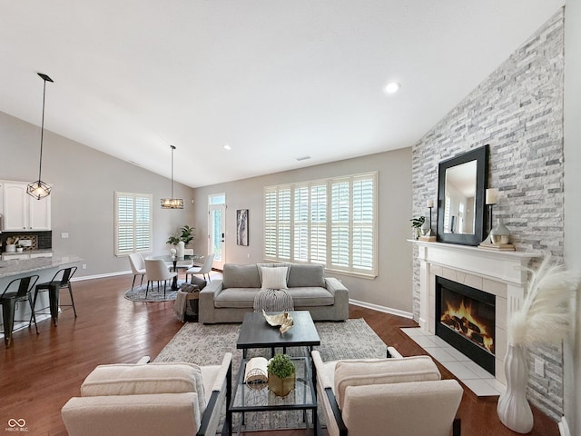9302 N Bayland Dr, Mccordsville, IN 46055 - living room featuring lofted ceiling, dark wood-type flooring, a tiled fireplace, and recessed lighting