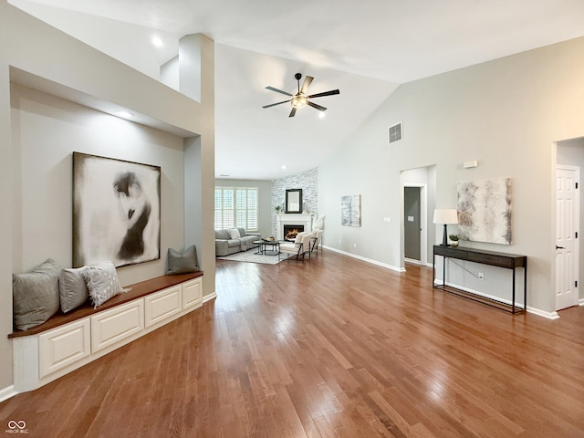 9302 N Bayland Dr, Mccordsville, IN 46055 - living room with ceiling fan, high vaulted ceiling, a fireplace, and wood finished floors