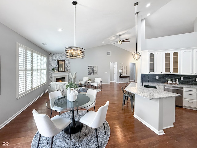 9302 N Bayland Dr, Mccordsville, IN 46055 - dining room featuring a ceiling fan, lofted ceiling, a large fireplace, dark wood-style floors, and recessed lighting