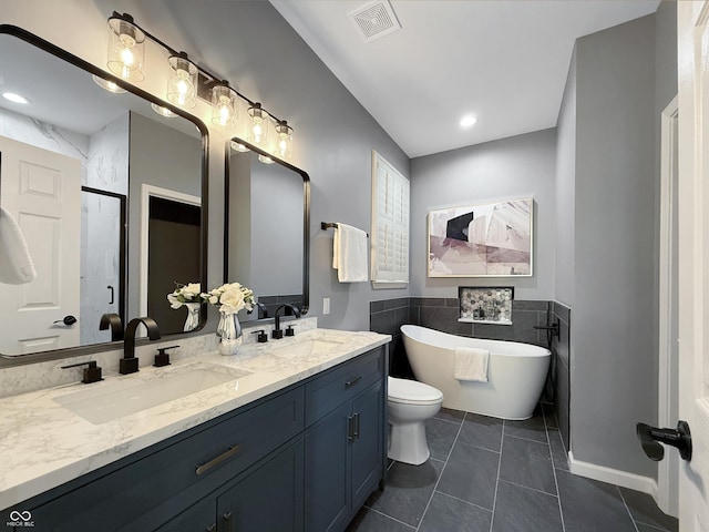 9302 N Bayland Dr, Mccordsville, IN 46055 - full bathroom with double vanity, a soaking tub, a stall shower, tile patterned floors, and tile walls