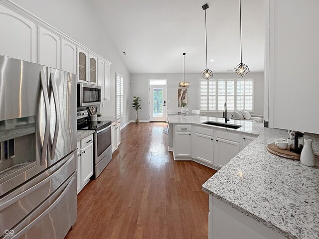 9302 N Bayland Dr, Mccordsville, IN 46055 - kitchen featuring stainless steel appliances, dark wood finished floors, vaulted ceiling, white cabinetry, and pendant lighting