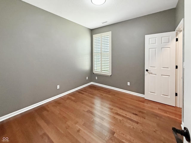 9302 N Bayland Dr, Mccordsville, IN 46055 - unfurnished bedroom featuring wood finished floors and baseboards