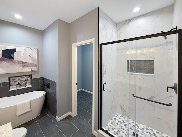 9302 N Bayland Dr, Mccordsville, IN 46055 - full bath featuring a soaking tub, a marble finish shower, tile walls, recessed lighting, and tile patterned floors