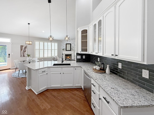 9302 N Bayland Dr, Mccordsville, IN 46055 - kitchen with a peninsula, stainless steel dishwasher, white cabinets, and decorative backsplash