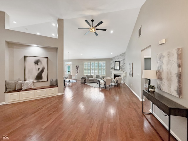 9302 N Bayland Dr, Mccordsville, IN 46055 - living room featuring high vaulted ceiling, a ceiling fan, light wood-style floors, and a fireplace