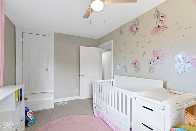 3045 Ruckle St, Indianapolis, IN 46205 - bedroom with light carpet, ceiling fan, and a crib