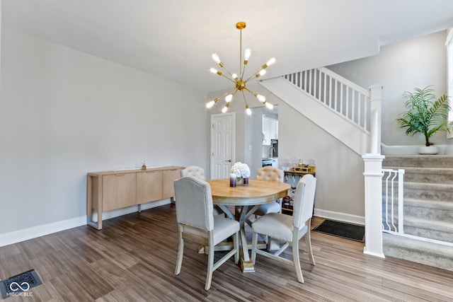 3045 Ruckle St, Indianapolis, IN 46205 - dining room with stairs, wood finished floors, and a chandelier