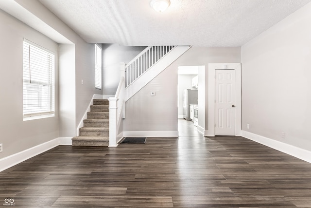 3045 Ruckle St, Indianapolis, IN 46205 - stairway with a textured ceiling and wood finished floors