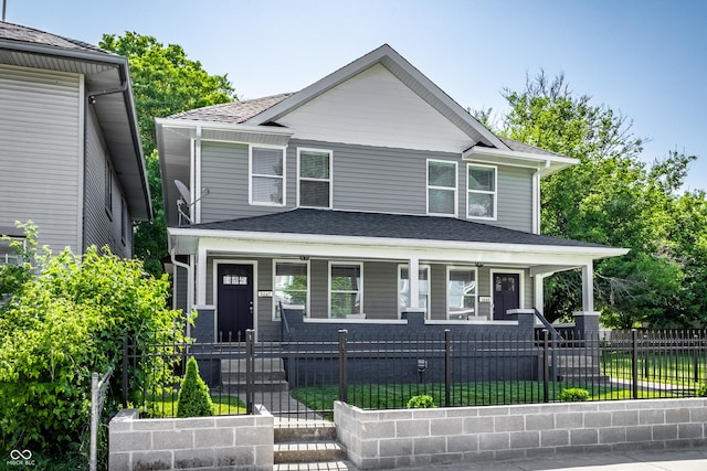 3045 Ruckle St, Indianapolis, IN 46205 - view of front of property with covered porch, a fenced front yard, a gate, and a shingled roof