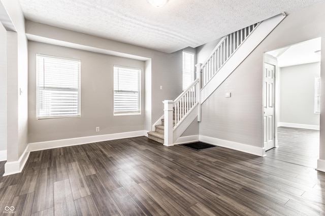 3045 Ruckle St, Indianapolis, IN 46205 - entryway with stairway, dark wood-style floors, and a textured ceiling