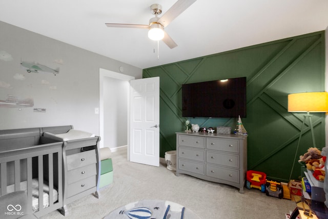 3045 Ruckle St, Indianapolis, IN 46205 - carpeted bedroom featuring a crib and ceiling fan
