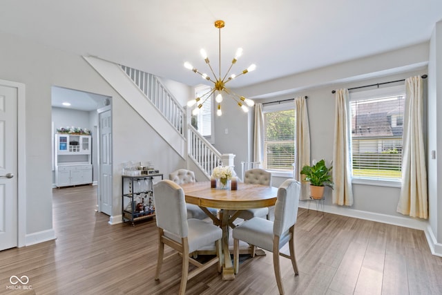 3045 Ruckle St, Indianapolis, IN 46205 - dining space with stairway, a chandelier, and wood finished floors