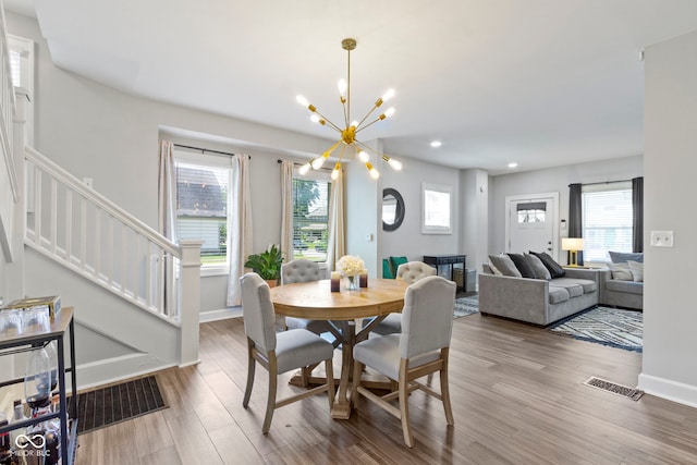 3045 Ruckle St, Indianapolis, IN 46205 - dining area featuring stairs, wood finished floors, healthy amount of natural light, a chandelier, and recessed lighting