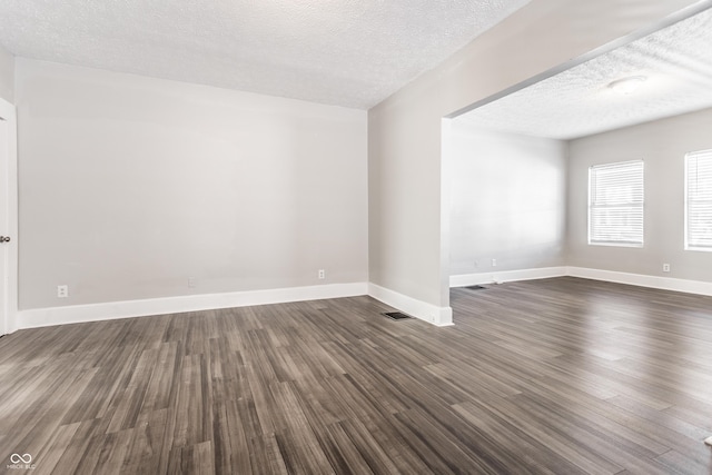 3045 Ruckle St, Indianapolis, IN 46205 - empty room with a textured ceiling and dark wood-style flooring